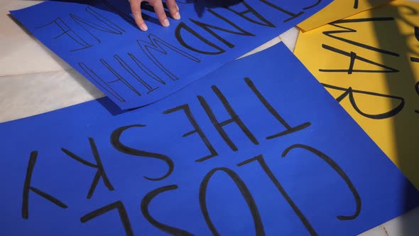 Message placard with inscription Stand With Ukraine for support Ukraine people in war with Russia. 