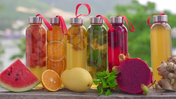 A Set of Colorful Glass Bottles with Different Flavors of Kombucha Drink Such As Watermelon Orange