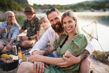 Happy multigeneration family on summer holiday trip, barbecue by lake / Photodune, Misc