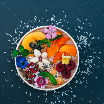 Bowl with tropical fruit decorated with flowers, mint, coconut flakes / Photodune, Misc