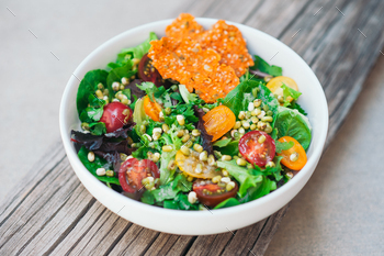 Fresh sald of cherry tomatoes, mung bean, carrot chips and flat bread on wooden background / Photodune, Misc