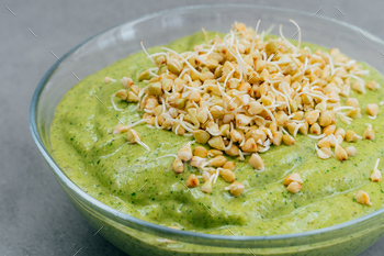 Homemade spinach smoothie in bowl covered with buckwheat sprouts. Vegan smoothie / Photodune, Misc