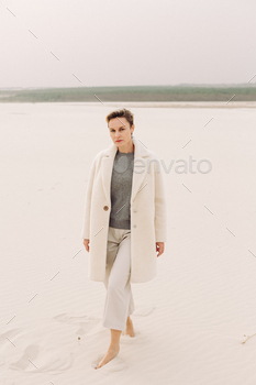 Lifestyle portrait of carefree mature business woman in formal outfit on the Moroccan desert. / Photodune, Misc