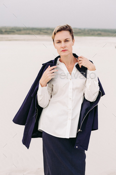 Lifestyle portrait of carefree mature business woman in formal outfit on the Moroccan desert. / Photodune, Misc