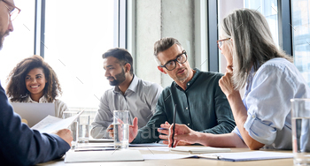 Diverse businesspeople executive team negotiating at boardroom meeting. / Photodune, Misc