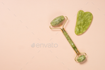 Jade roller and gua sha stone massager top view / Photodune, Misc