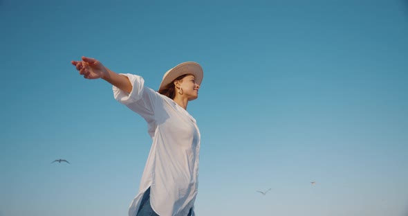 Happy woman on a background of blue sky