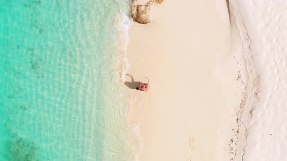 Couple on tropical beach takes a selfie. Vertical video format for social media