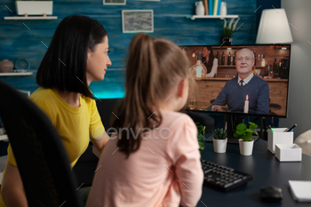 Smart school girl and mom on online conference