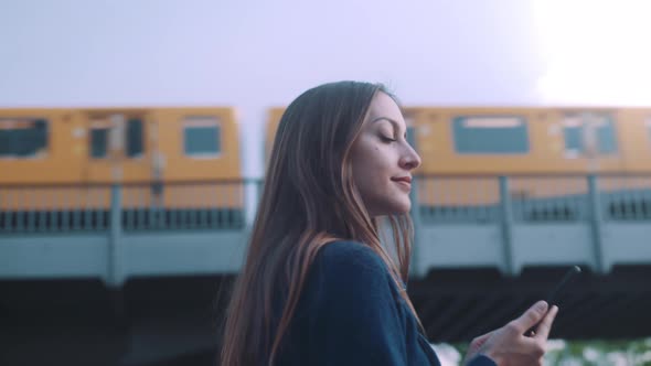 Young woman walks around with phone in her hands