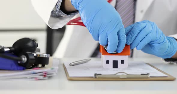 Doctor Puts Stethoscope to Roof of Small House  Movie