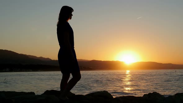 Silhouette of a Female Admiring Sunrise on Marbella Seashore