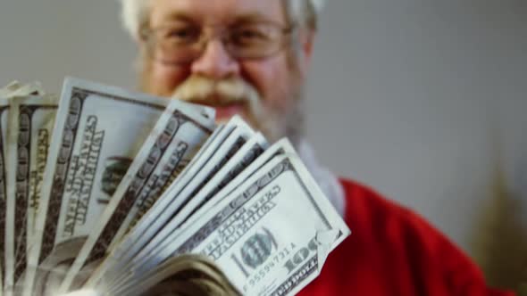 Santa claus fanning currency notes