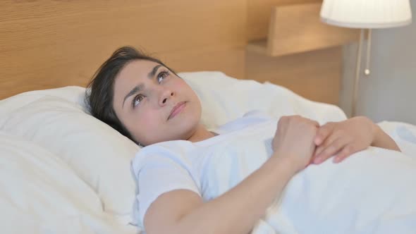 Young Indian Woman Awake in Bed Thinking