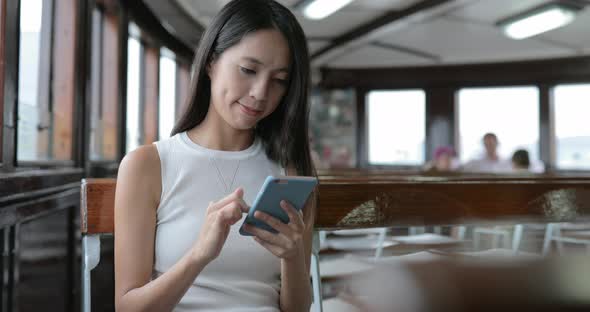 Woman using city map inside ferry 