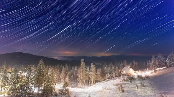 Stars Moving Above Small House In The Mountains In WInter. Ukraine, Carpathian