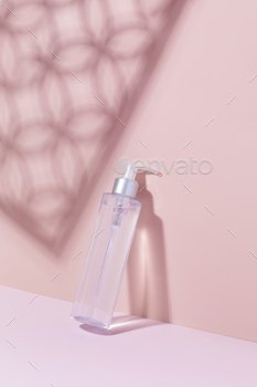 A mock-up of a cosmetic product on a pink background with shadows. Cleansing tonic for the face / Photodune, Misc