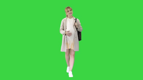 Happy Healthy Pregnancy Pregnant Young Blonde Caucasian Woman Walking on a Green Screen, Chroma Key.