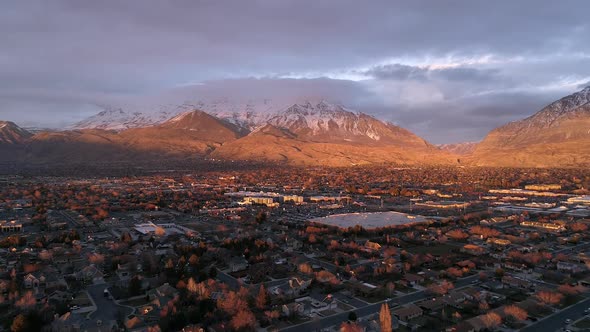 Aerial view flying over the city of Orem at sunset