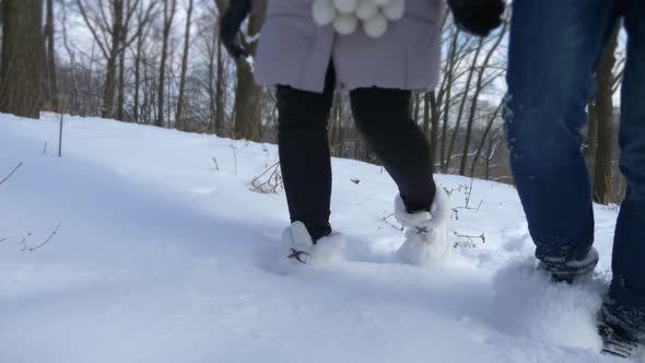 Happy Couple Holding Hands Walk On Snow In Winter Park. Slow Motion Snow Sunny Day 2