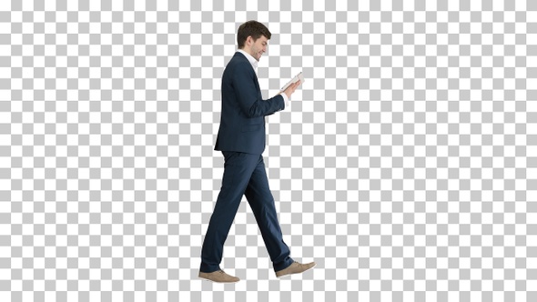 Handsome businessman walking and working on a tablet, Alpha Channel