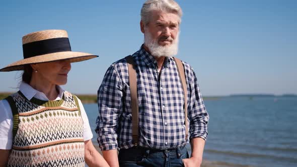 Healthy Elderly Retirement Couple Walking Together on the Seashore or Ocean Enjoying Romantic