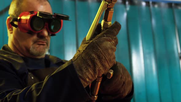 Welder adjusting welding torch