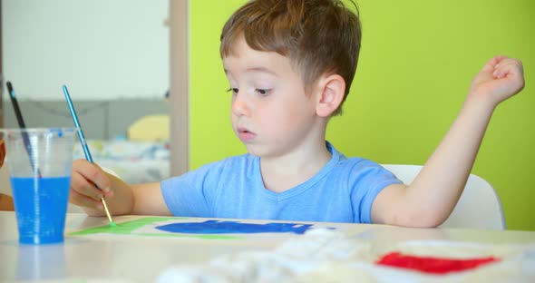 Happy Cute Children a Girl of 78 Years Old and Preschool Boy Paint at Home with Watercolors Sitting