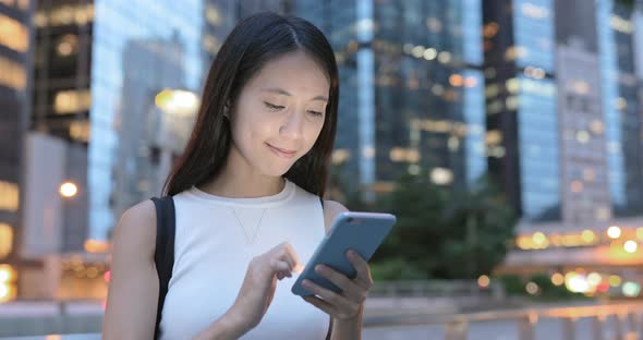 Woman using cellphone at night 