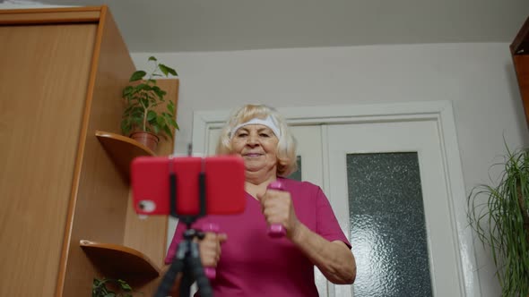 Old Senior Grandmother Woman Doing Workout with Dumbbells Running Fitness Sport Activity at Home