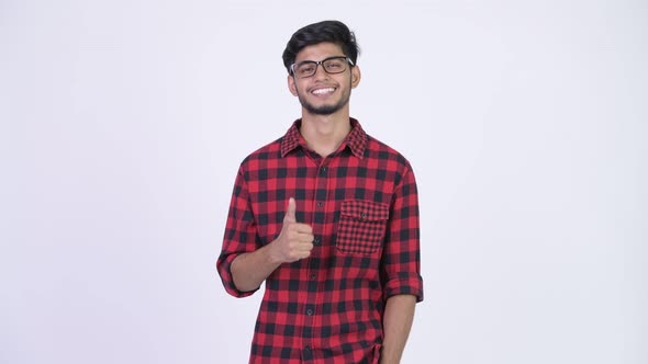 Young Happy Bearded Indian Hipster Man Giving Thumbs Up