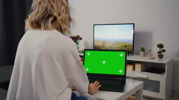 Caucasian Woman make web search on laptop with Greenscreen and Chroma Key.