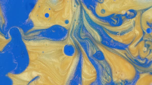 Vibrant Blue and Gold Ink Bubbles Background Texture Rotating