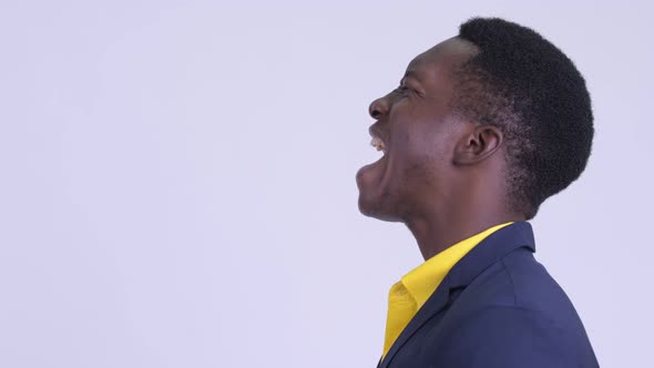Closeup Profile View of Angry Young African Businessman Shouting