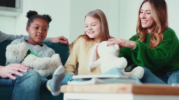 Happy multinational family talking on the sofa