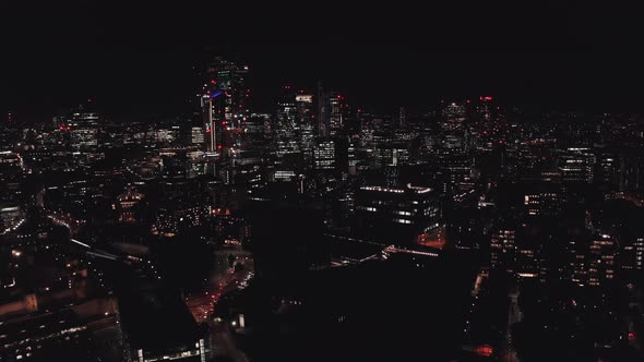 Aerial View to the Illuminated Tower Bridge and Skyline of London at Night UK