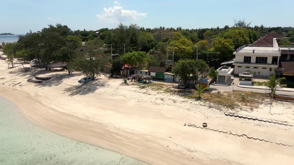 Lonely empty sandy beach on Gili Air Island during corona virus pandemic in Asia.Aerial backwards fl