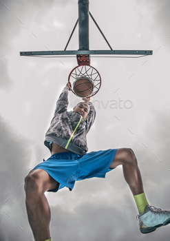 own triumphant at camera after a slam dunk – Basketball player sroring for his team