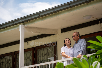 Happy asian couples standing at the balcony and talking together. / Photodune, Misc