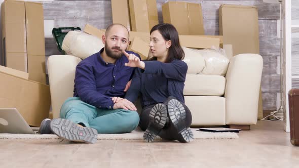 Young Couple Sitting on the Floor of Their New Apartment