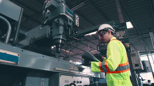 Smart Factory Worker Using Machine in Factory Workshop