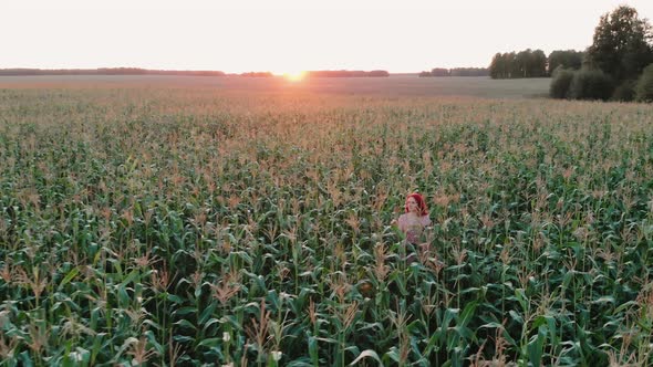 A Young Girl Happily Walking in Slow Motion Through a Corn Field