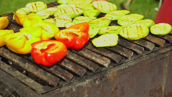 Zucchini and bell pepper fries on the grill. Vegetarian dish. Cooking vegetables without oil