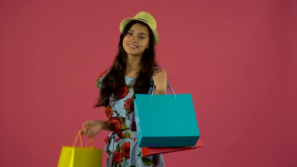 Girl Dancing with Packages in Their Hands, Pink Background