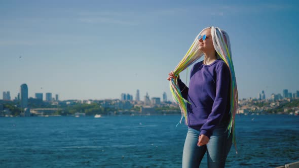Young Hipster Woman Walking Along Embankment Against Istanbul and Bosphorus