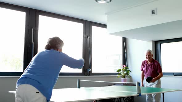 Senior couple playing table tennis