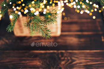 Christmas tree branch with garland in basket on wooden table / Photodune, Misc