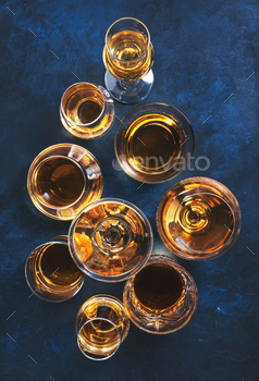 Strong alcohol drinks, hard liquors, spirits and distillates set in glasses / Photodune, Misc