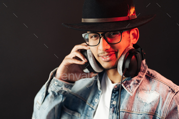 Carefree dark skinned guy listens lively music / Photodune, Misc