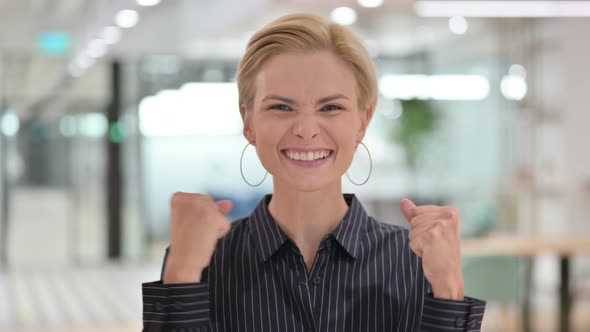 Excited Young Businesswoman Celebrating Success